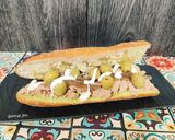 A picture of step 4 of Tuna and Anchovy Sandwich with Guacamole and Olives.