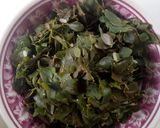 A picture of step 6 of Rice and beans with moringa leaves.