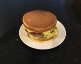A picture of step 12 of Vanilla Layer Cake filled withLenon and Rasberry and frosted with Fresh Lemon Cream.