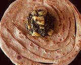 A picture of step 14 of Alu meethi with paratha.