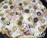 A picture of step 2 of Tawa Veg Pizza with Olives.
