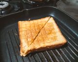 A picture of step 4 of Grilled sandwich filled with hummus, red sauce and vegetables.
