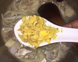 A picture of step 2 of Fish peepered soup garnish with parsely.