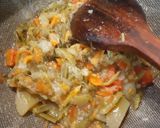A picture of step 3 of Manchow Soup / Veg soup topped with Crispy fried noodles.
