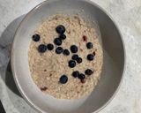 A picture of step 2 of Porridge with blueberries and strawberry jam.