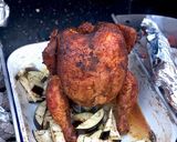 A picture of step 5 of Beer can chicken on the Braai (BBQ) with coal charred corn on the cob.