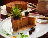 A picture of step 7 of Maize Malva Pudding drizzled with custard.
