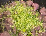 A picture of step 7 of Chicken Hearts Yakitori style (no skewer) Leek Green on top.