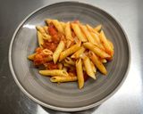 A picture of step 9 of Penne al'arrabiata (pasta with a spicy tomato sauce).