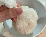 A picture of step 2 of Onigiri with salmon flakes.