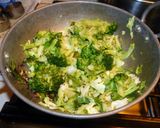 A picture of step 6 of Fried rice topped with green veggies.