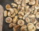 A picture of step 2 of Buttered Mushrooms in a little white wine and Balsamic Vinegar.