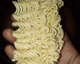 A picture of step 3 of Indomie with potato and dried fish.