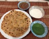A picture of step 3 of Akki roti with green chutney,curd and mango launji.