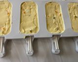 A picture of step 4 of Mango and Passion Fruit Shrikhand Popsicles.