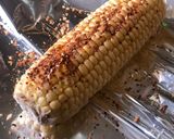 A picture of step 4 of Beer can chicken on the Braai (BBQ) with coal charred corn on the cob.