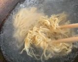 A picture of step 2 of Thai style egg noodles stir-fry served with fried egg.