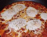 A picture of step 8 of Shakshuka with hot dogs.