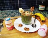 A picture of step 4 of Banana Moringa Yakult Milkshake topped with Walnuts.