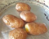 A picture of step 1 of Baked Potatoes with Masala Beans.