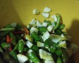 A picture of step 1 of Fried chilli with onion and raw mango.