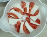A picture of step 2 of Haloumie cheese with tomato.
