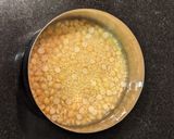 A picture of step 1 of Moong and Chana Hummus on toasted bread.