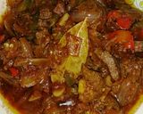 A picture of step 5 of Kibda (Egyptian liver sauce) and French fries.