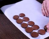 A picture of step 11 of Chocolate Macarons with a White Chocolate Ganache filling.