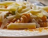 A picture of step 6 of Pasta sizzler sizzling with hot chilli powder, veggies, cheese.