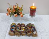 A picture of step 5 of Banana cinnamon bread rolls with chocolate syrup garnish.