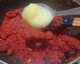 A picture of step 3 of Gajar Ka Halwa with milk and cashews.