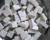 A picture of step 5 of Shahi paneer with white gravy.