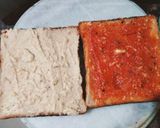 A picture of step 3 of Grilled sandwich filled with hummus, red sauce and vegetables.