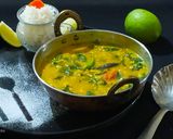 A picture of step 8 of Lasooni Dal Palak with Gondhoraj lebu/ lemon.