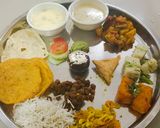 A picture of step 1 of Lunch plate kheer served with puri.
