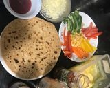 A picture of step 2 of Roti pizza on tawa.