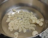 A picture of step 2 of Cheesy Mini Macaroni Pasta Pizza.