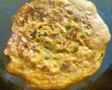 A picture of step 3 of Besan Chila with veggies.