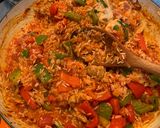 A picture of step 4 of Spanish style tomato and chicken baked rice.