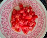 A picture of step 1 of Tomato Raita seasoned with Mustard seeds.