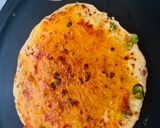A picture of step 2 of Stuffed Leftover Rice Paratha topped with Schezwan Sauce.