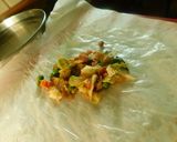 A picture of step 4 of A novel recipe- ravioli/samosa  made with rice paper stuffed with veggies.