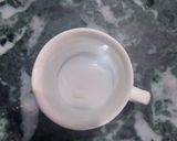 A picture of step 1 of Cardamom and tulsi tea.