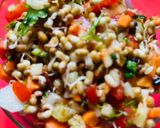 A picture of step 3 of Sprout Salad with carrots cucumber tomatoes.