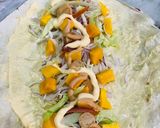 A picture of step 2 of Mango 🥭 sausages wrap.