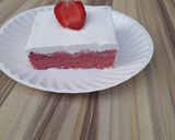 A picture of step 12 of Strawberry milk cake with whipped cream frosting.