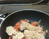 A picture of step 2 of Maggi with tomato onion.