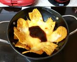 A picture of step 2 of My Cheeky Nancho,s with Cheese also a blob of whisky BBQ sauce😋.