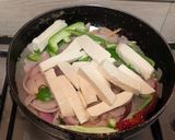 A picture of step 5 of Paneer Jalfrezi with steamed white rice.